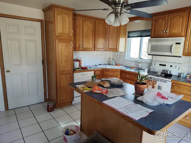 a kitchen with stainless steel appliances a sink a stove a refrigerator and cabinets