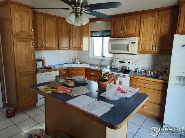 a kitchen with stainless steel appliances granite countertop a sink dishwasher stove refrigerator and cabinets