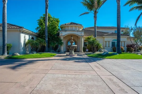 a view of a house with a yard and potted plants