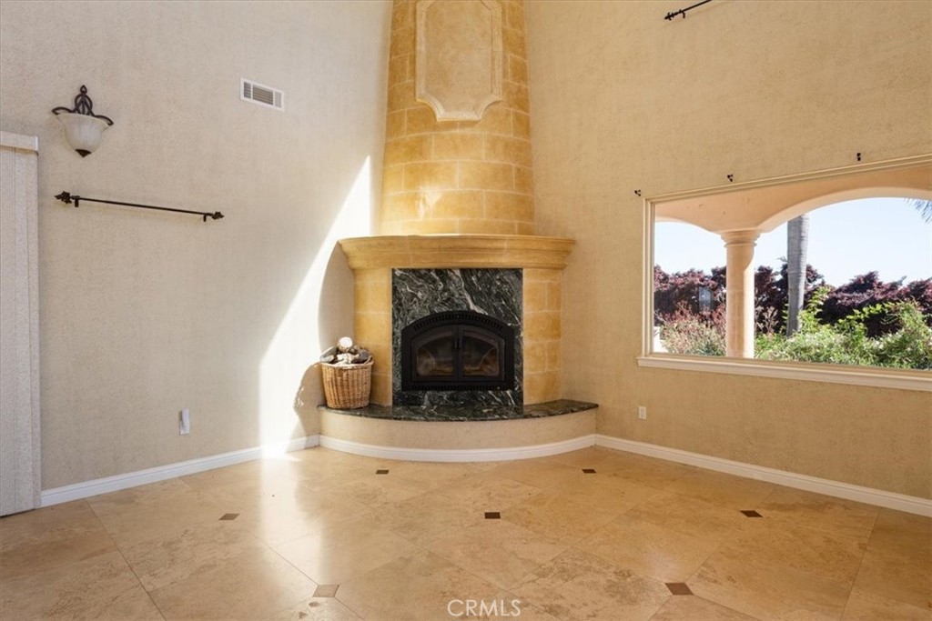 1685 Scenic View Way Nipomo, CA 93444 - Photo 11 of 64 a living room with a fireplace and a floor to ceiling window
