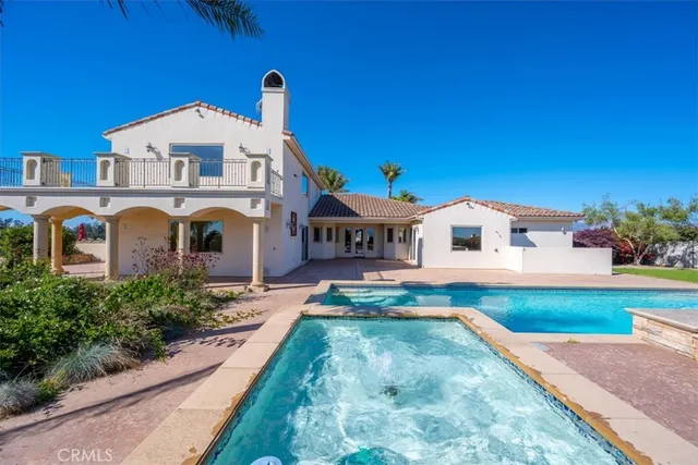 a view of a swimming pool with an outdoor seating and a yard