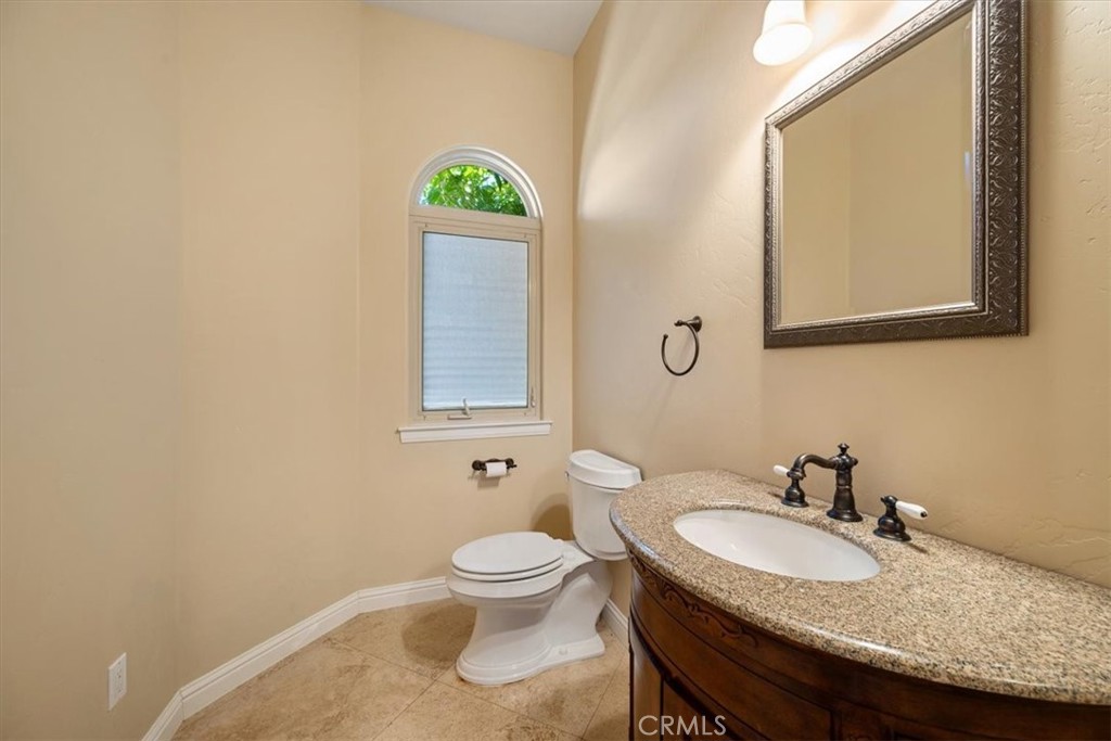 1685 Scenic View Way Nipomo, CA 93444 - Photo 30 of 64 a bathroom with a granite countertop toilet sink and mirror
