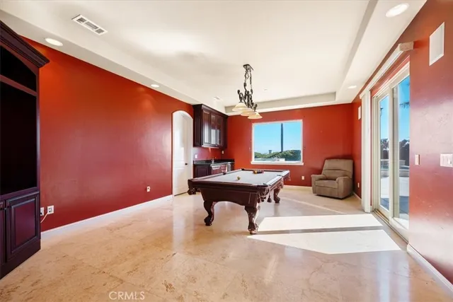 a large kitchen with a large window and stainless steel appliances