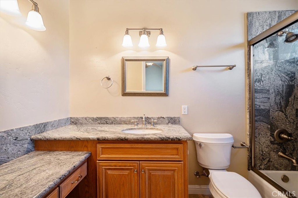 1685 Scenic View Way Nipomo, CA 93444 - Photo 37 of 64 a bathroom with a granite countertop toilet sink and mirror