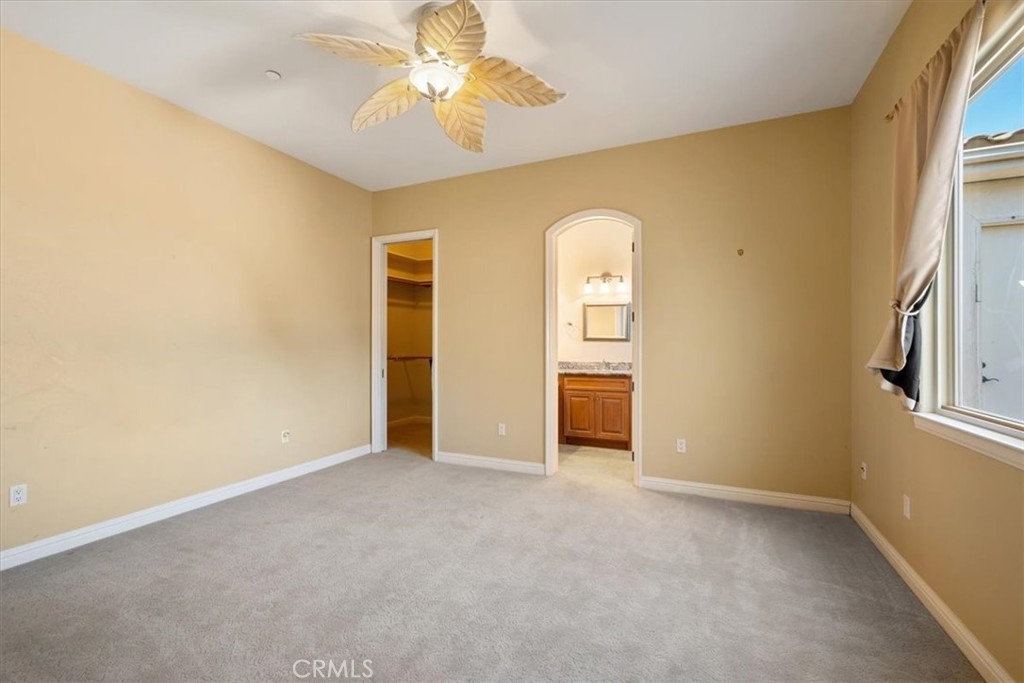 1685 Scenic View Way Nipomo, CA 93444 - Photo 38 of 64 an empty room with windows and chandelier fan