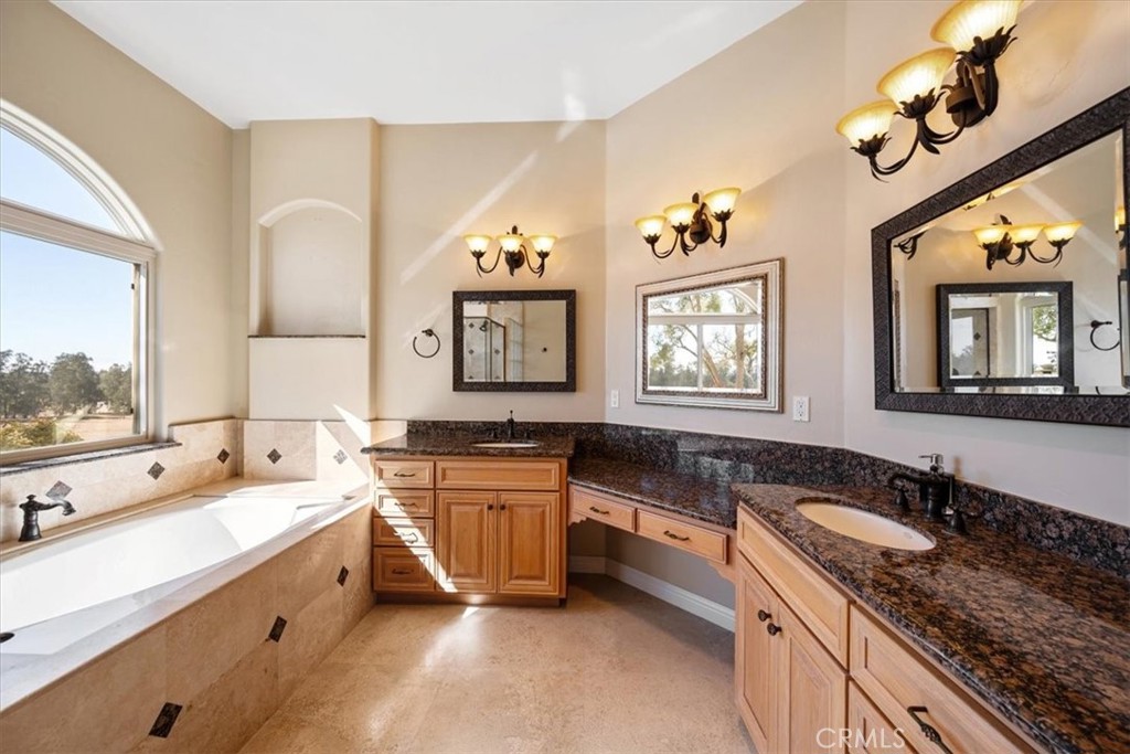 1685 Scenic View Way Nipomo, CA 93444 - Photo 39 of 64 a spacious bathroom with a granite countertop double vanity sink a mirror and a bathtub