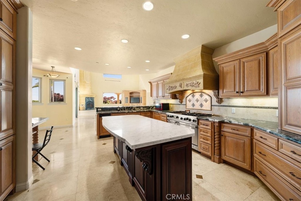 1685 Scenic View Way Nipomo, CA 93444 - Photo 49 of 64 a kitchen with kitchen island granite countertop a sink stove and refrigerator