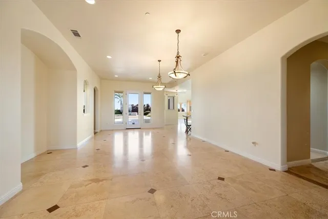 a living room with a fireplace and a floor to ceiling window