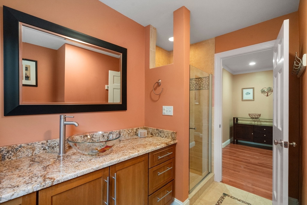 24 Russett Hill Road Sherborn, MA 01770 - Photo 14 of 39 a bathroom with a granite countertop sink and a mirror