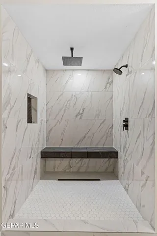 a bathroom with a bathtub and shower