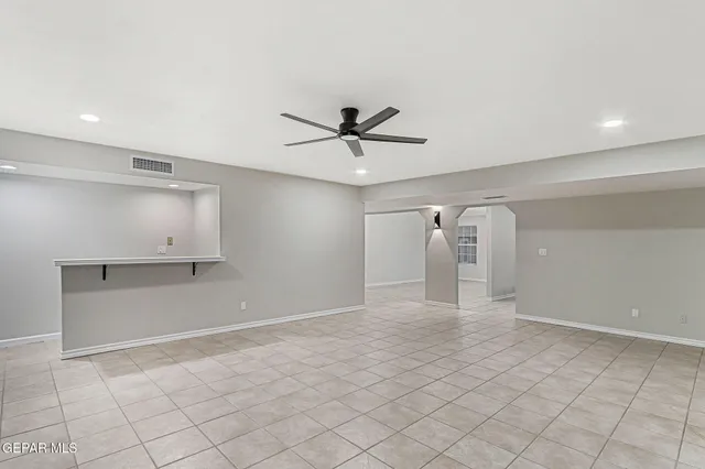 a view of an empty room with a fan