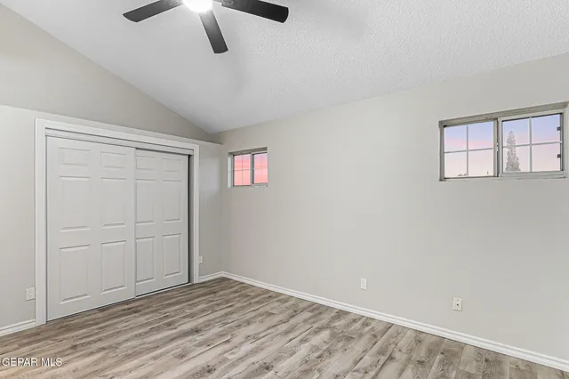 a bathroom with a granite countertop sink a mirror and bathtub