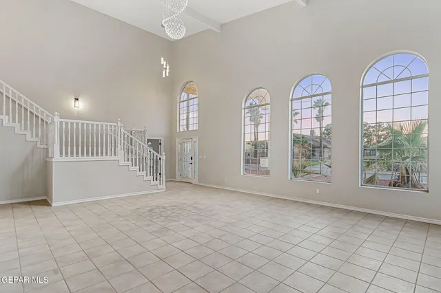 an empty room with windows and outdoor view