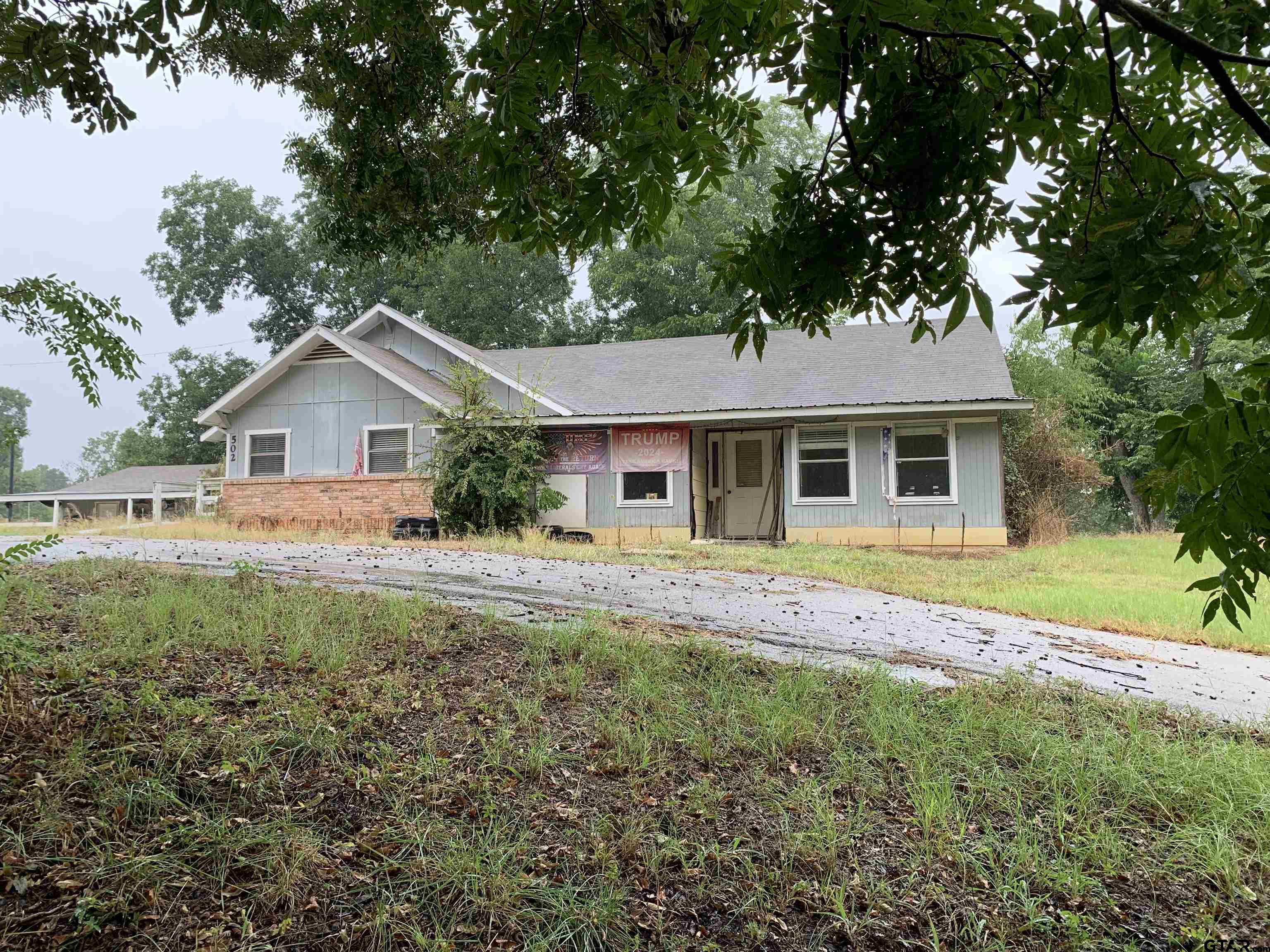 502 County Road 3264 Quitman, TX 75783 - Photo 1 of 37 a front view of a house with garden