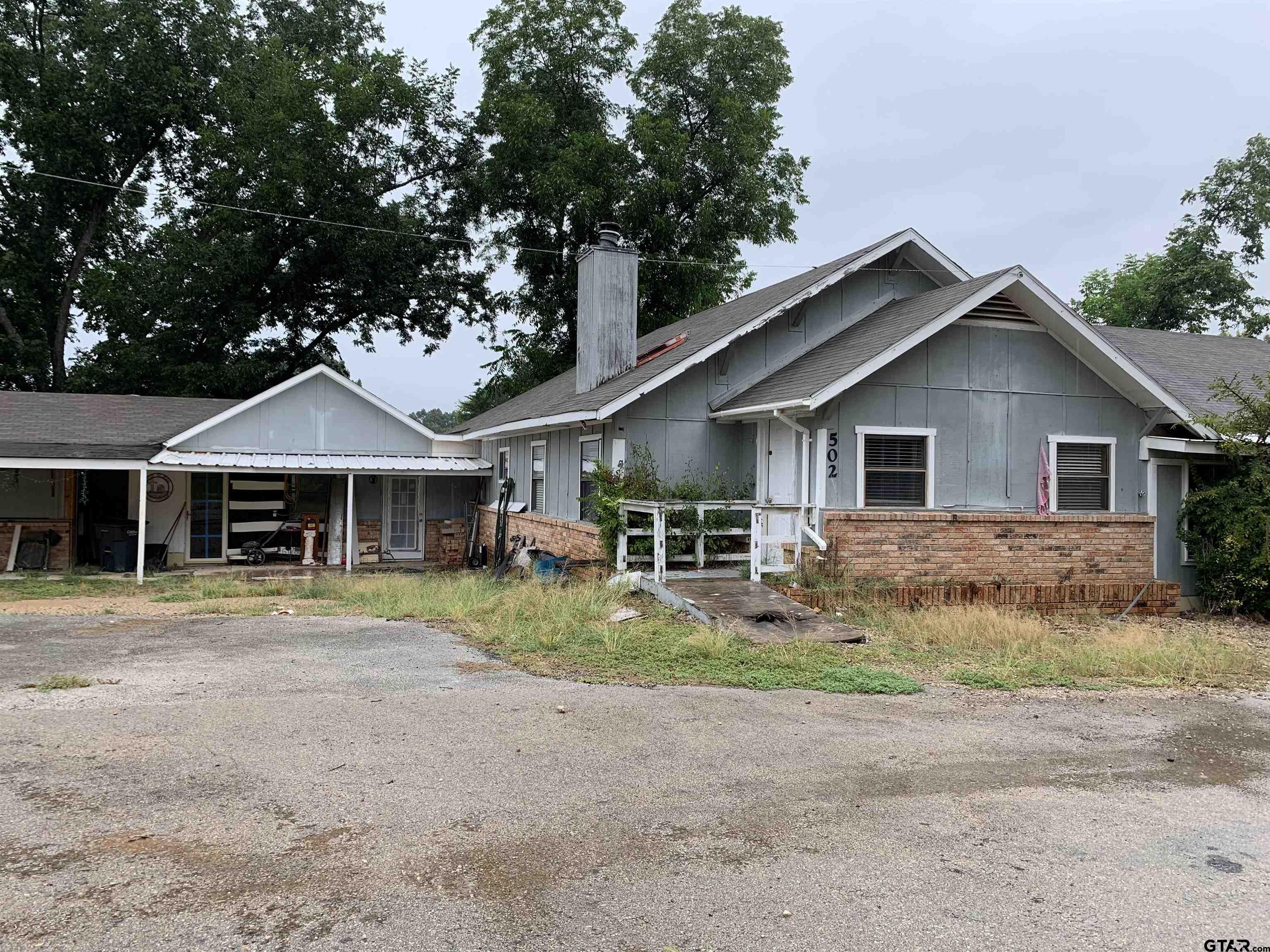 502 County Road 3264 Quitman, TX 75783 - Photo 2 of 37 a front view of a house with a yard and garage
