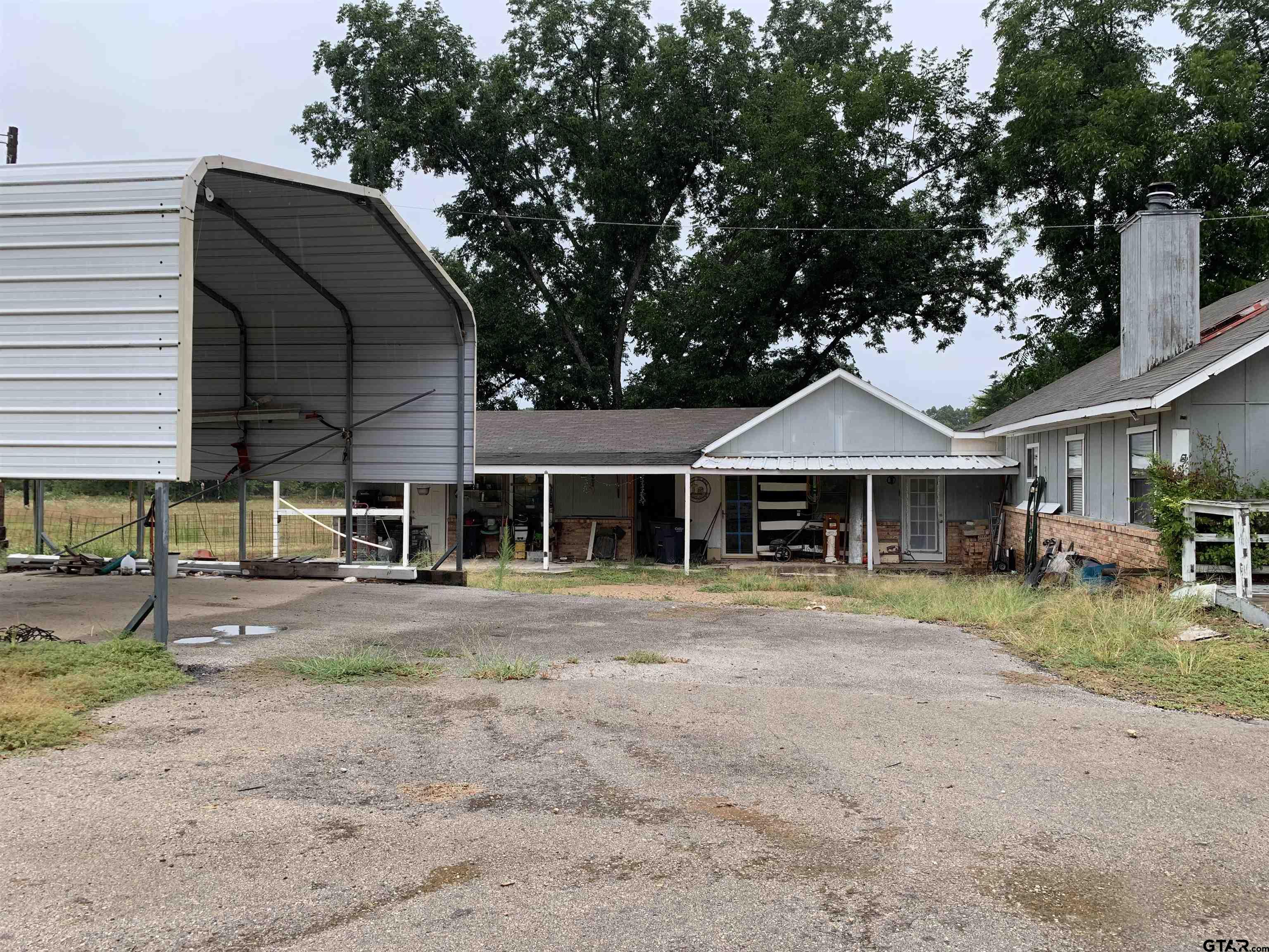 502 County Road 3264 Quitman, TX 75783 - Photo 3 of 37 a front view of a house with a garden