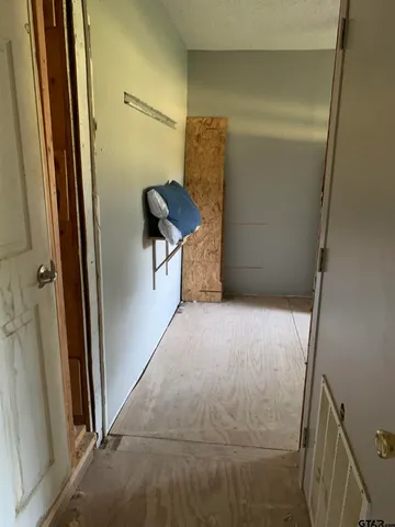 a bathroom with a walk in closet and shower
