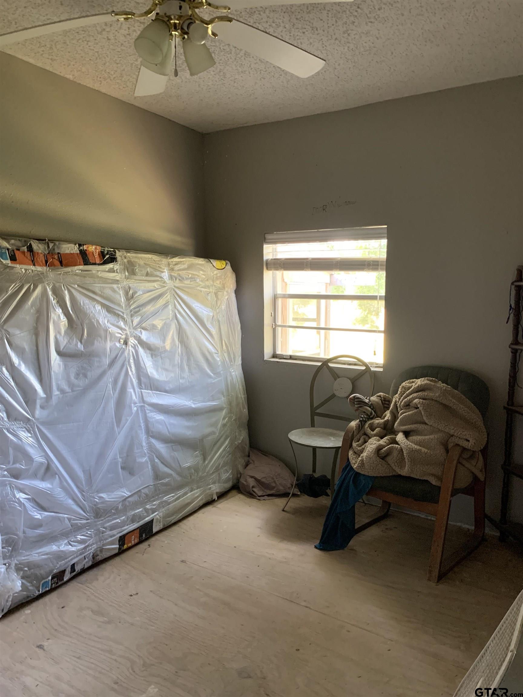 502 County Road 3264 Quitman, TX 75783 - Photo 34 of 37 a bedroom with a bed and a chandelier