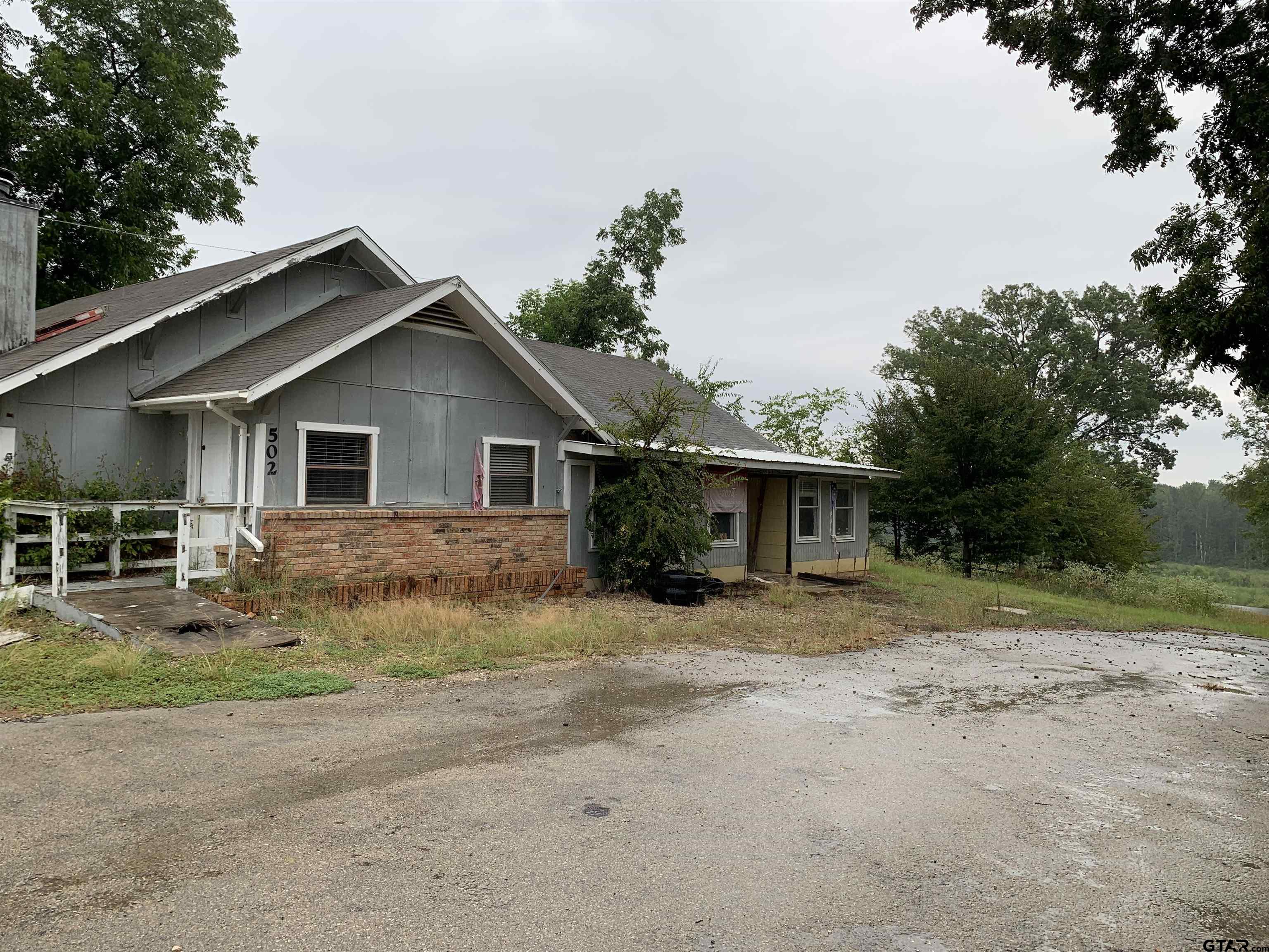 502 County Road 3264 Quitman, TX 75783 - Photo 6 of 37 a view of a house with a yard and large trees