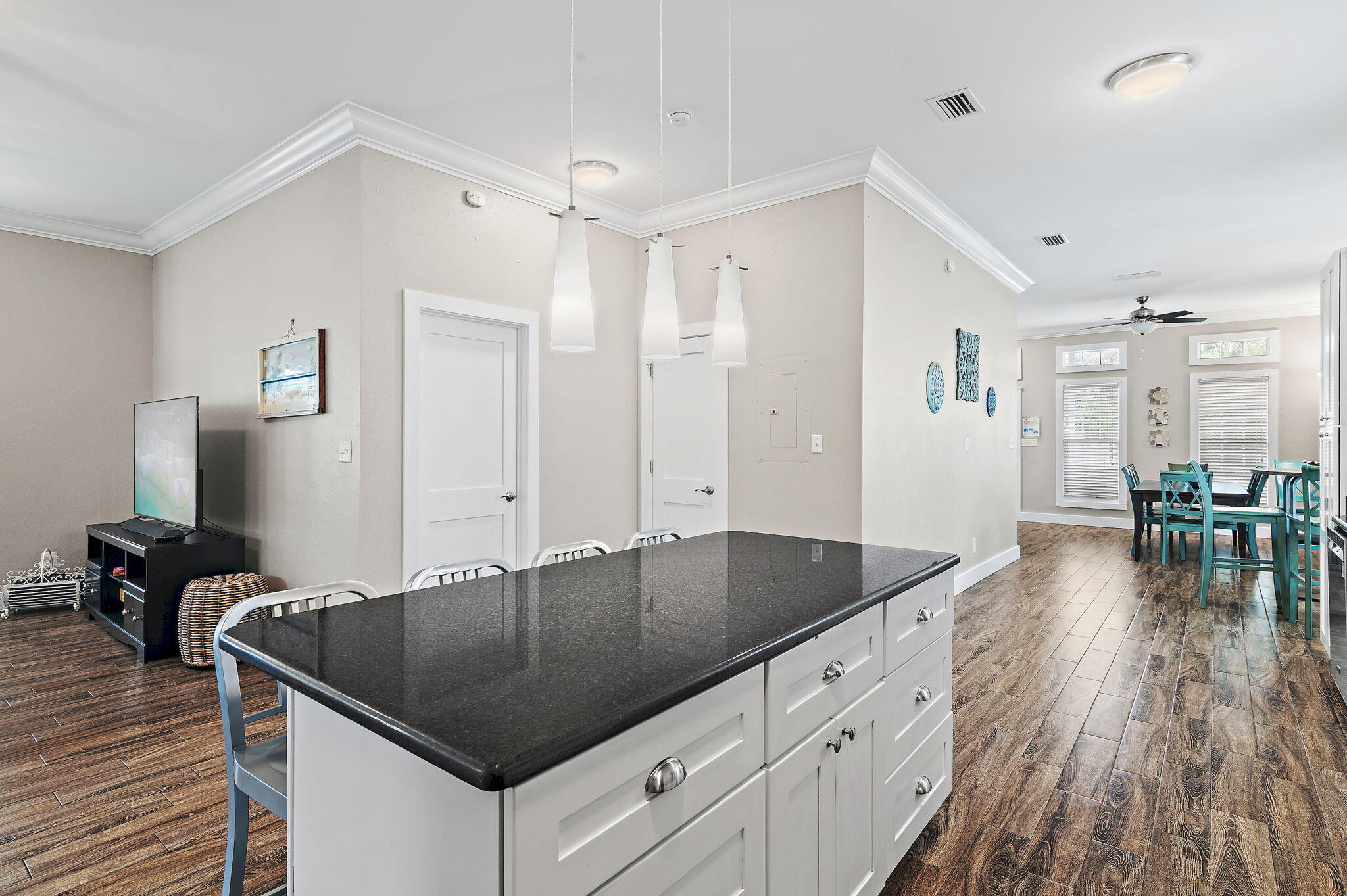 78 Pelican Glide Lane Inlet Beach, FL 32461 - Photo 11 of 61 a kitchen with granite countertop a table chairs stove and wooden floor