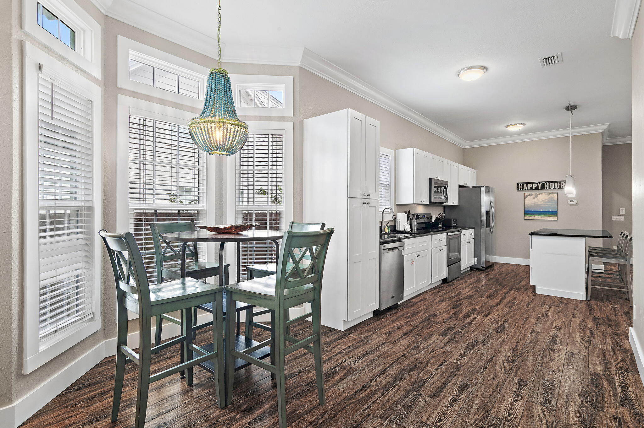 78 Pelican Glide Lane Inlet Beach, FL 32461 - Photo 17 of 61 a kitchen with stainless steel appliances kitchen island granite countertop a table chairs and a wooden floor