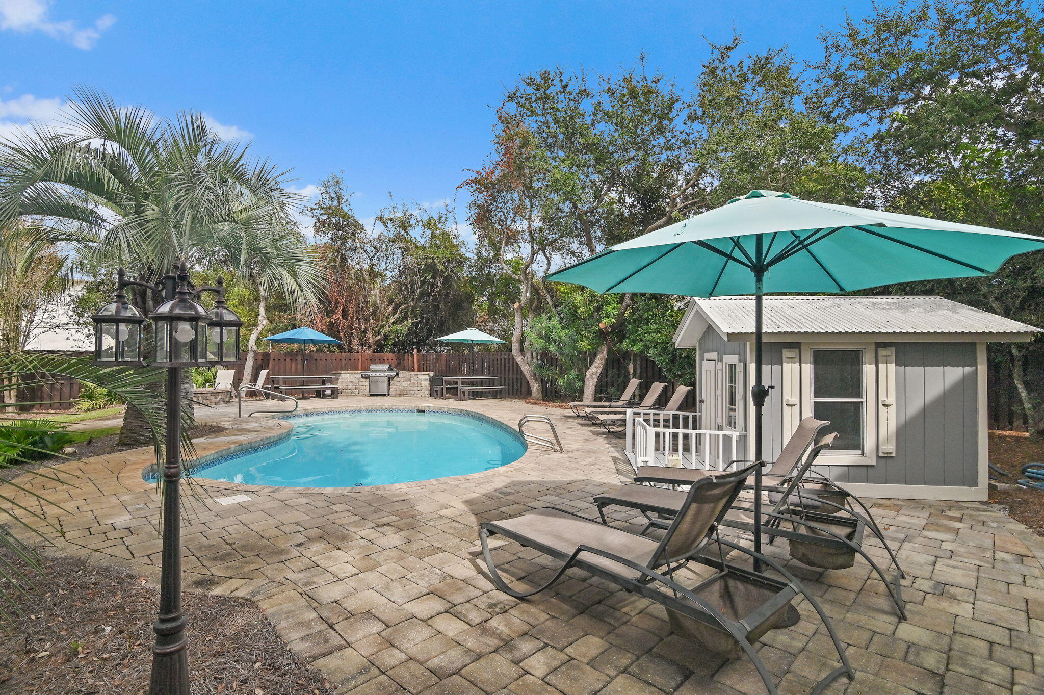 78 Pelican Glide Lane Inlet Beach, FL 32461 - Photo 40 of 53 a view of a patio with a table chairs and a barbeque