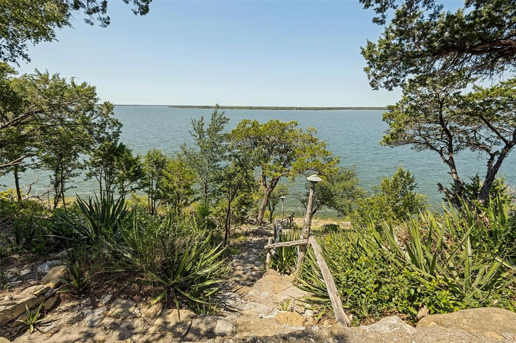 111 Live Oak Road Whitney, TX 76692 - Photo 20 of 30 Stone path with lights leads directly down to the lake. Swim, kayak, whatever you fancy.