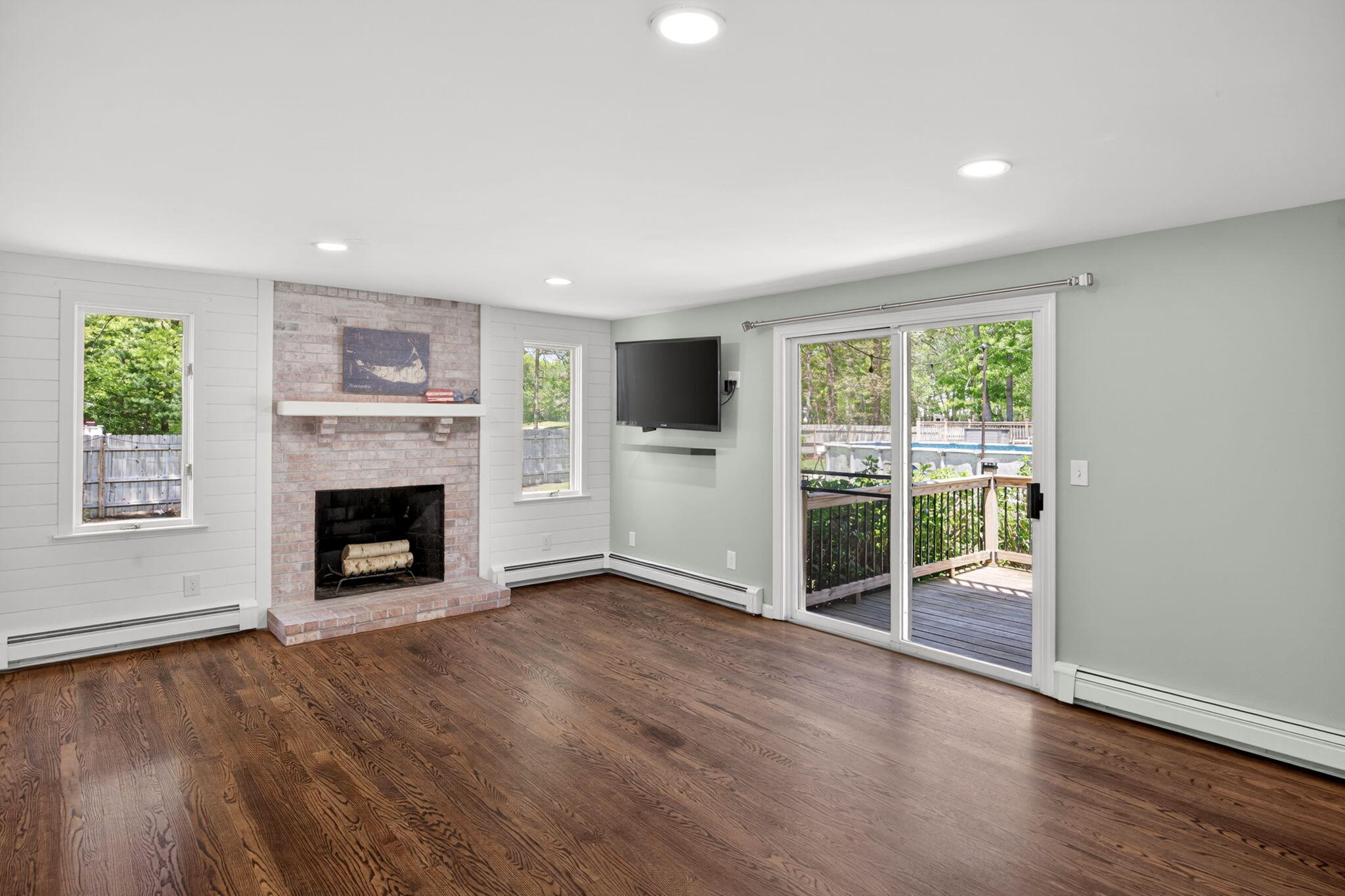 12 Sarah Lawrence Road Sandwich, MA 02563 - Photo 11 of 54 an empty room with windows fire place and a fireplace