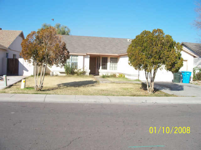 9018 West Granada Road Phoenix, AZ 85037 - Photo 1 of 2 a view of a house with a yard and road