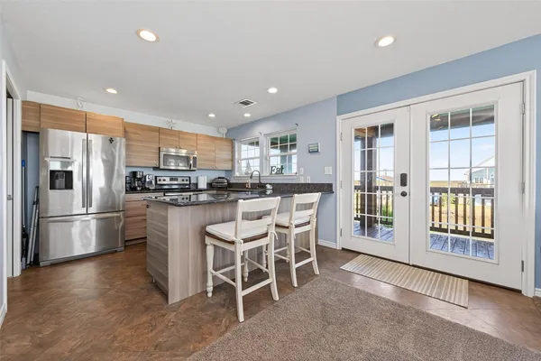 a kitchen with stainless steel appliances granite countertop a stove and a refrigerator