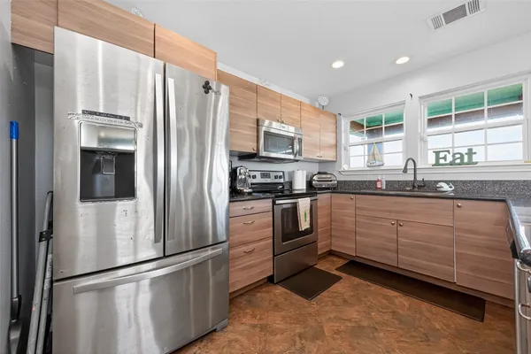 a kitchen with sink and window