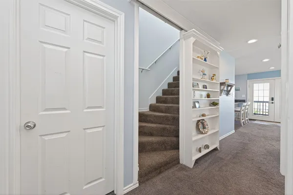 a spacious bedroom with a bed and a chandelier