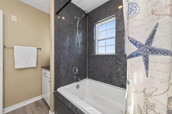 a bathroom with a bathtub and shower