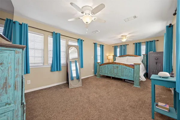 a bedroom with bed and a large window