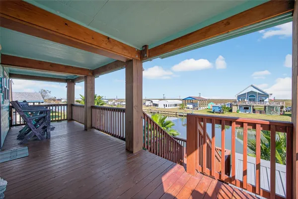 a view of a balcony with floor to ceiling windows with wooden floor