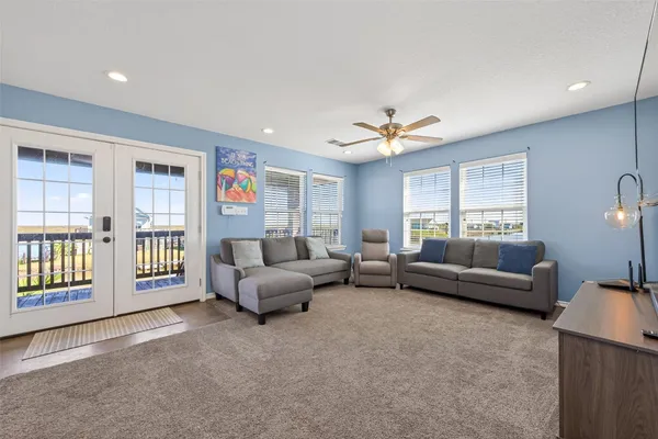 a living room with furniture and kitchen view