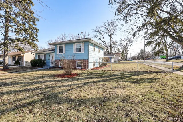 a view of a house with a yard covered in snow