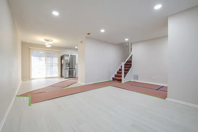 a view of an empty room with stairs