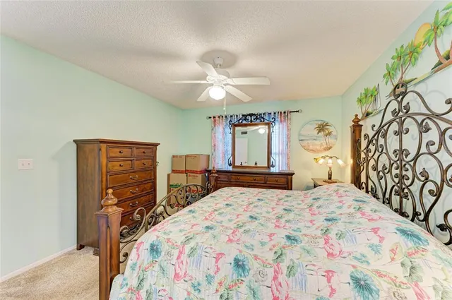 a bedroom with a bed dresser and a window