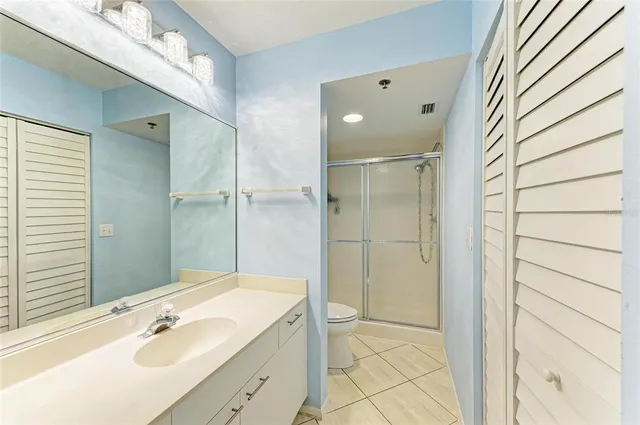 a bathroom with a shower sink and mirror