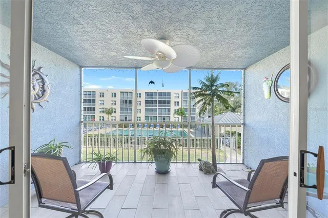 a view of a livingroom with furniture and floor to ceiling window