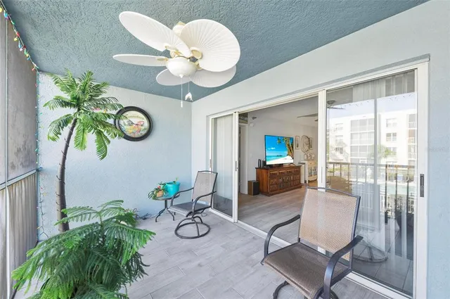 a view of a livingroom with furniture and a large window