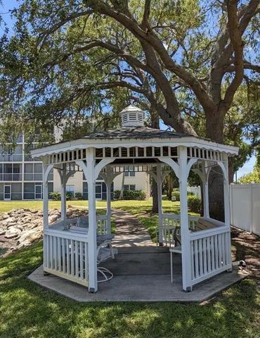 a view of roof deck with barbeque grill and wooden fence