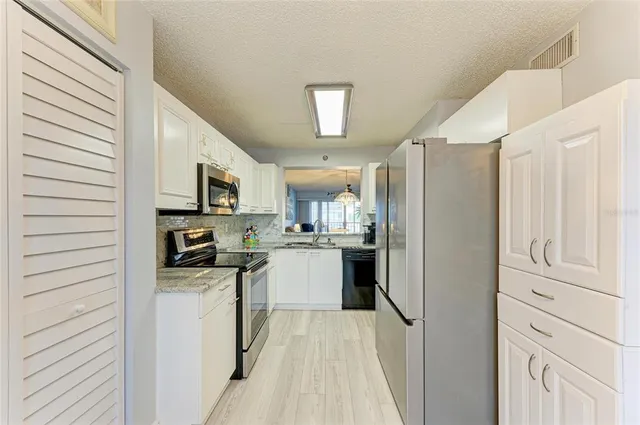 a kitchen with a refrigerator stove and sink