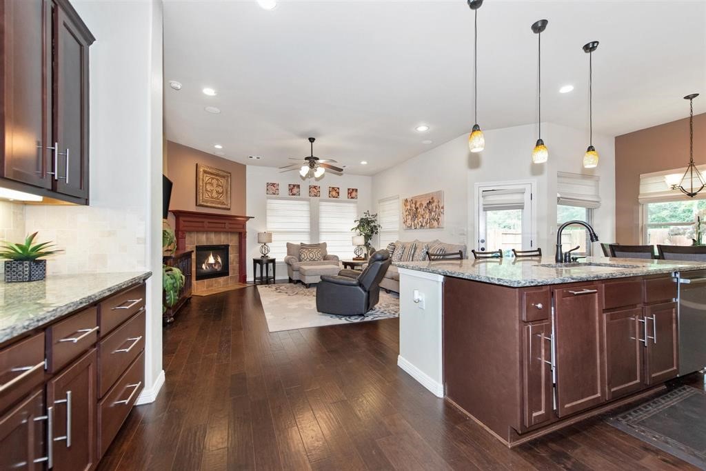 8323 Floating Heart Court Conroe, TX 77385 - Photo 15 of 43 a large kitchen with kitchen island a large island in the center and stainless steel appliances