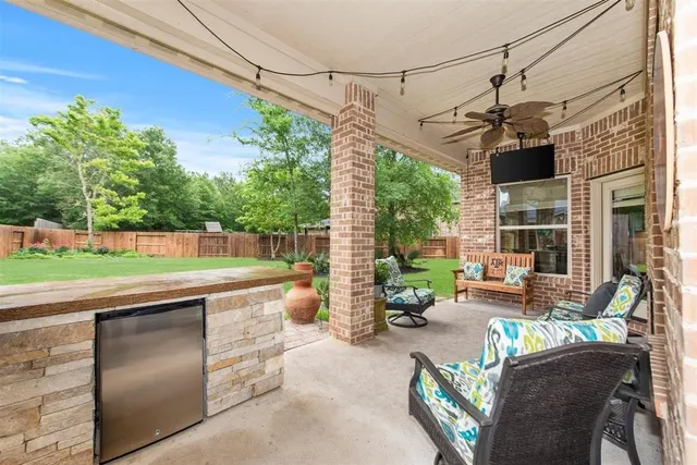 a view of a patio with a table chairs and a backyard