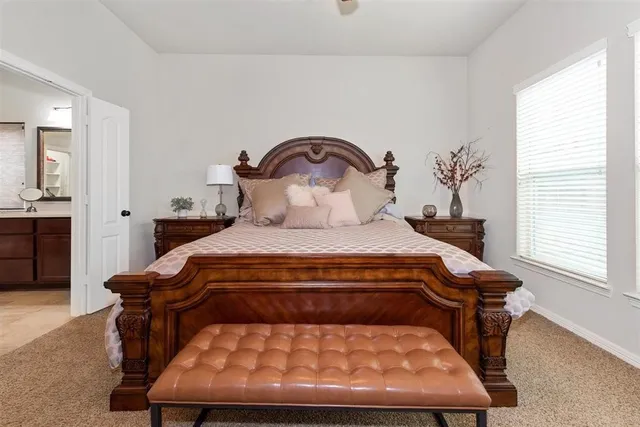 a bedroom with a bed and window