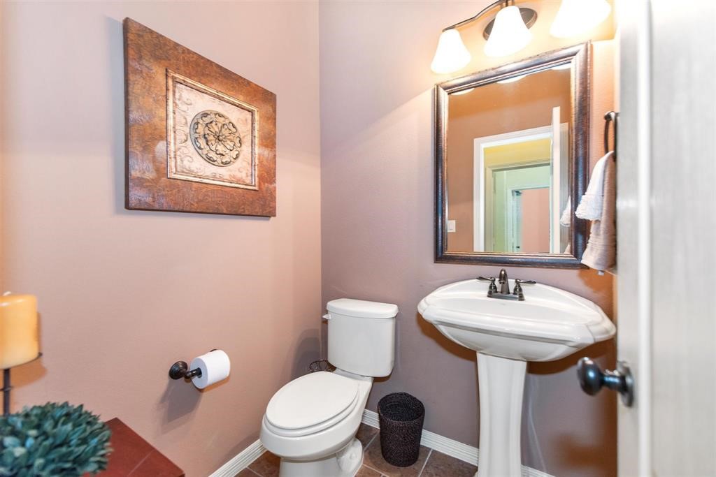 8323 Floating Heart Court Conroe, TX 77385 - Photo 36 of 43 a bathroom with a toilet sink and mirror