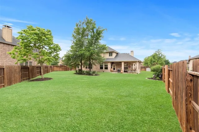 a front view of a house with yard and green space