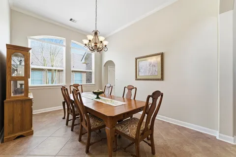 a view of a dining room with furniture and chandelier